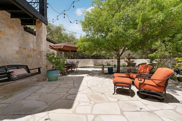 view of patio featuring fence and outdoor dining space