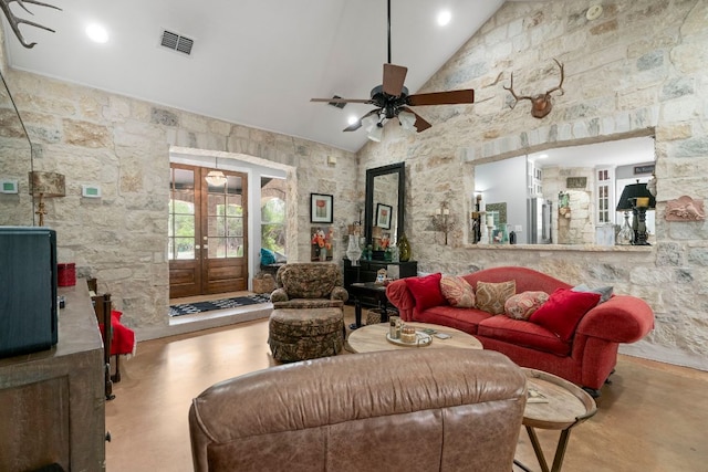 living area featuring french doors, visible vents, finished concrete flooring, ceiling fan, and high vaulted ceiling