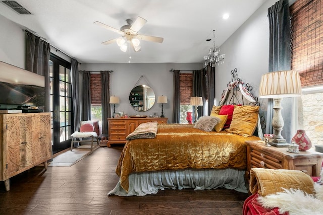 bedroom featuring wood finished floors, visible vents, and multiple windows