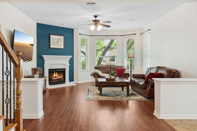 3614 Turkey Path Bnd, Cedar Park, TX 78613 - living area with ceiling fan, wood finished floors, a lit fireplace, and stairway