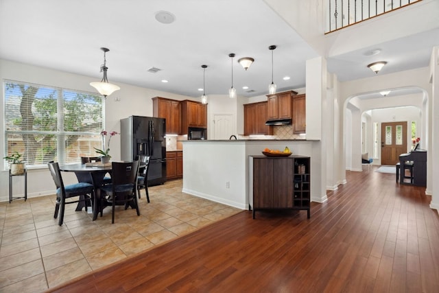 3614 Turkey Path Bnd, Cedar Park, TX 78613 - kitchen with black appliances, arched walkways, healthy amount of natural light, under cabinet range hood, and recessed lighting