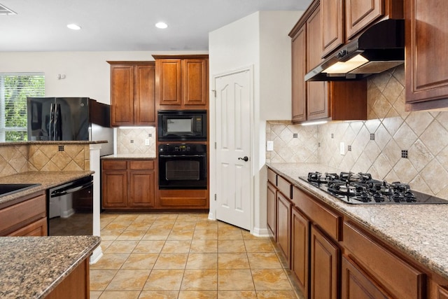 3614 Turkey Path Bnd, Cedar Park, TX 78613 - kitchen featuring black appliances, under cabinet range hood, brown cabinets, decorative backsplash, and recessed lighting