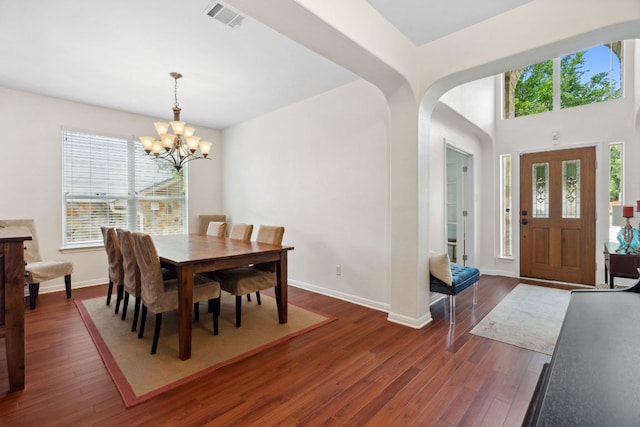 3614 Turkey Path Bnd, Cedar Park, TX 78613 - dining space featuring a chandelier, dark wood-style floors, and arched walkways