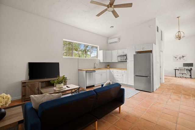 living room with light tile patterned floors, a wall mounted AC, ceiling fan, and high vaulted ceiling