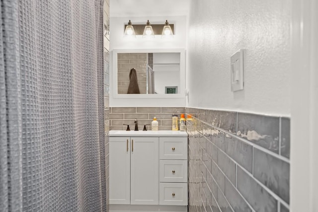 bathroom with tile walls, decorative backsplash, and vanity