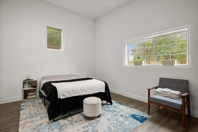 bedroom with baseboards and wood finished floors