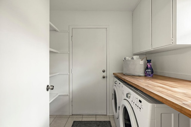 laundry room with separate washer and dryer, cabinet space, and light tile patterned flooring