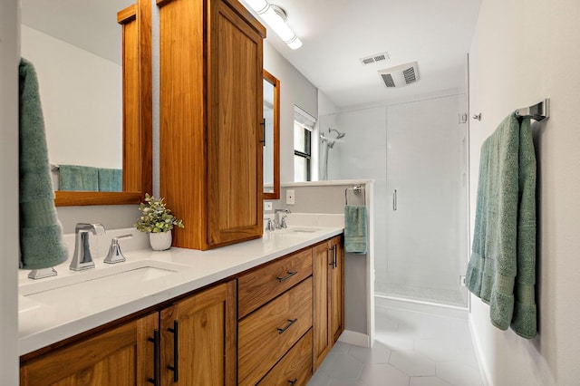 full bathroom featuring tile patterned floors, walk in shower, visible vents, and a sink