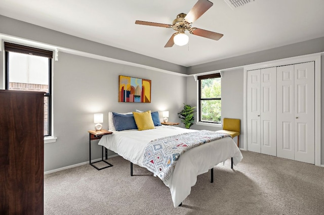 bedroom with a ceiling fan, a closet, carpet floors, baseboards, and visible vents
