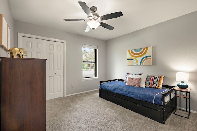 bedroom with baseboards, carpet floors, a closet, and ceiling fan