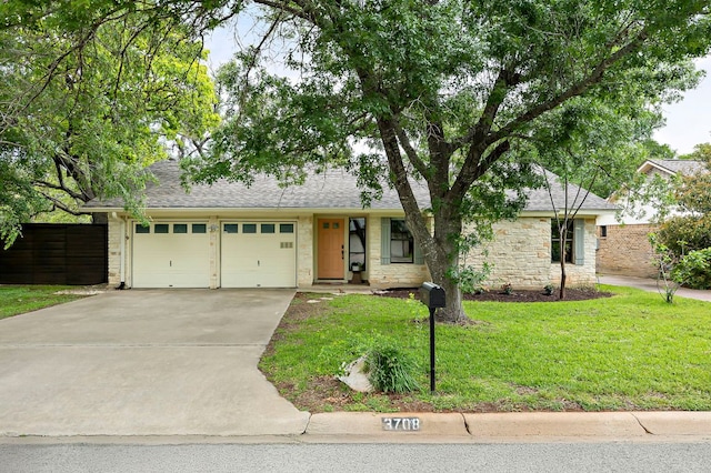 ranch-style house with concrete driveway, fence, a garage, and a front yard