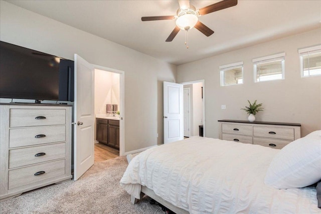 943 Lone Peak Way, Dripping Springs, TX 78620 - bedroom with multiple windows, ensuite bathroom, light colored carpet, and a ceiling fan