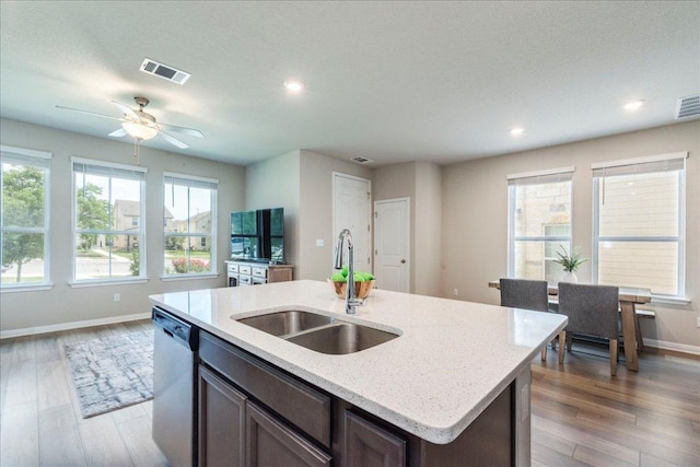 943 Lone Peak Way, Dripping Springs, TX 78620 - kitchen with a sink, dishwasher, baseboards, wood finished floors, and recessed lighting