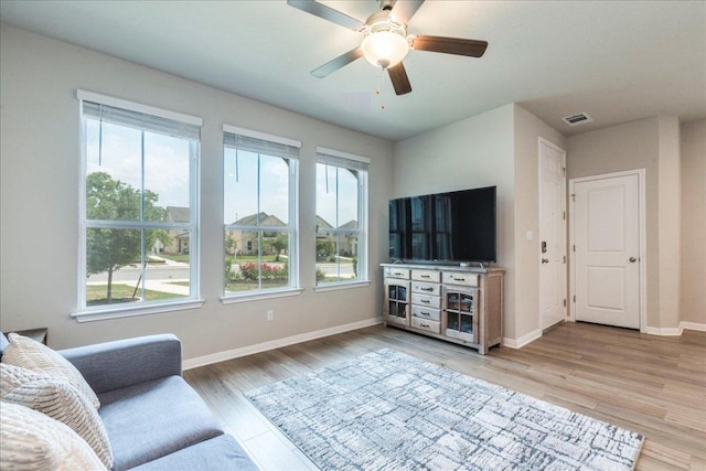 943 Lone Peak Way, Dripping Springs, TX 78620 - living room featuring plenty of natural light, light wood-style floors, baseboards, and a ceiling fan