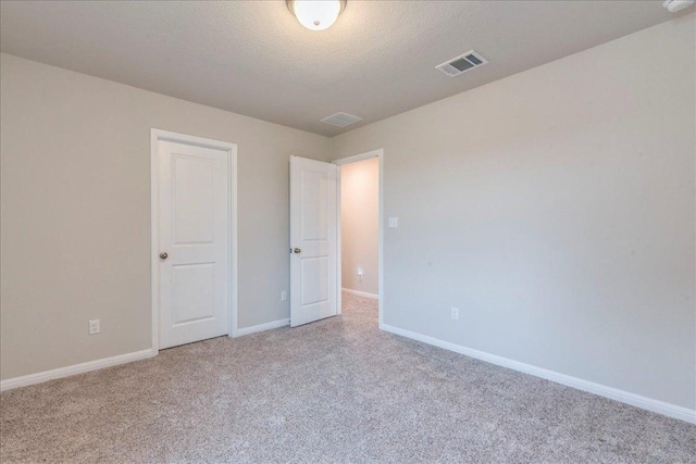 943 Lone Peak Way, Dripping Springs, TX 78620 - unfurnished bedroom with carpet flooring, baseboards, and a textured ceiling