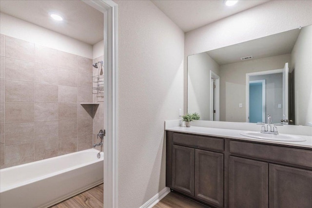 943 Lone Peak Way, Dripping Springs, TX 78620 - bathroom featuring wood finished floors, vanity, bathtub / shower combination, and recessed lighting