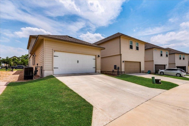 943 Lone Peak Way, Dripping Springs, TX 78620 - view of front of property featuring a garage, driveway, central AC unit, and a front yard