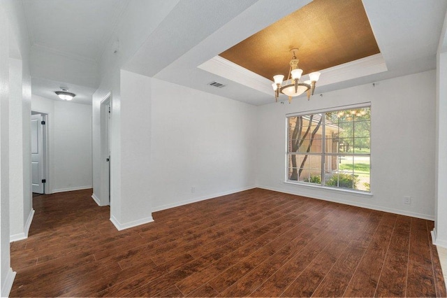 209 El Rio Dr, Lakeway, TX 78734 - spare room with a raised ceiling, dark wood-style flooring, a chandelier, and ornamental molding
