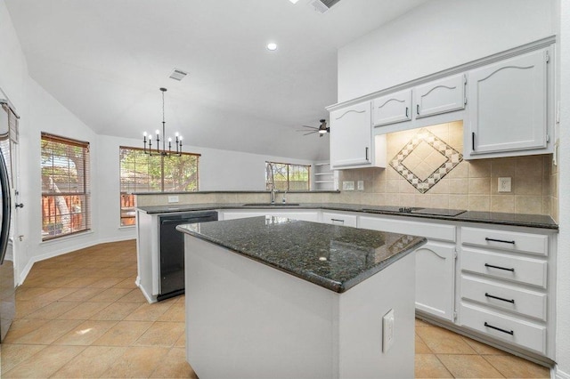 kitchen with a peninsula, light tile patterned flooring, ceiling fan with notable chandelier, decorative backsplash, and black appliances