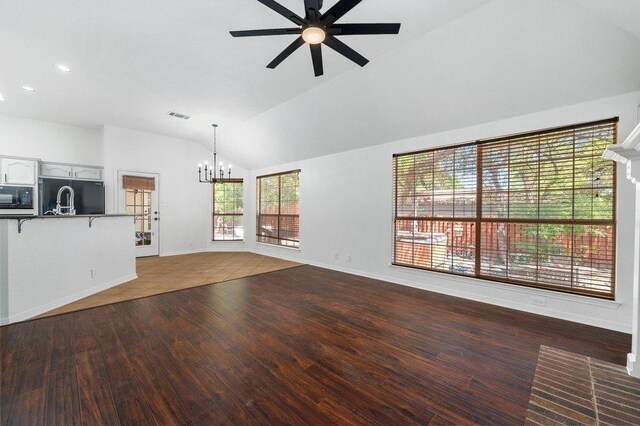 209 El Rio Dr, Lakeway, TX 78734 - unfurnished living room with a chandelier, vaulted ceiling, ceiling fan, wood finished floors, and recessed lighting