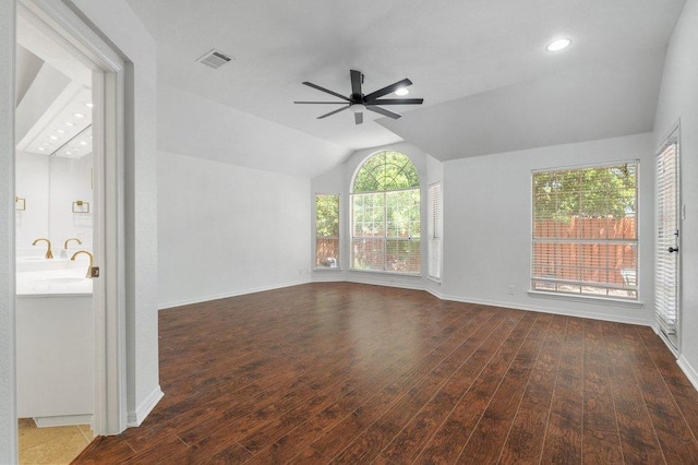 209 El Rio Dr, Lakeway, TX 78734 - unfurnished living room featuring lofted ceiling, wood finished floors, a ceiling fan, and recessed lighting
