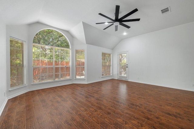 spare room featuring ceiling fan, vaulted ceiling, wood finished floors, and visible vents