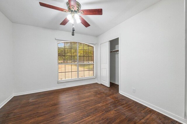 209 El Rio Dr, Lakeway, TX 78734 - unfurnished bedroom featuring dark wood finished floors, a closet, and a ceiling fan