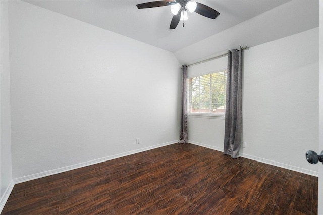 empty room featuring lofted ceiling, a ceiling fan, baseboards, and dark wood-style flooring