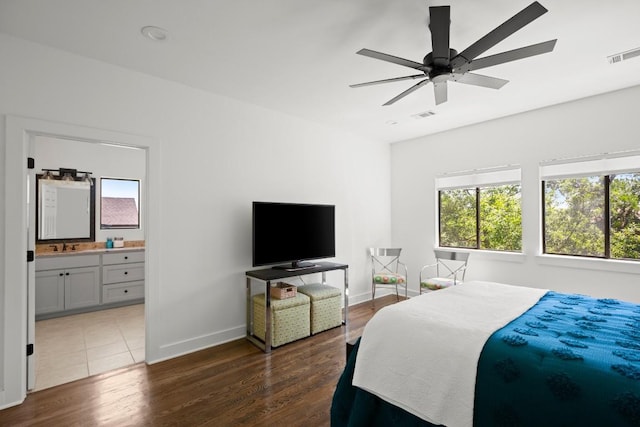bedroom featuring baseboards, multiple windows, and visible vents