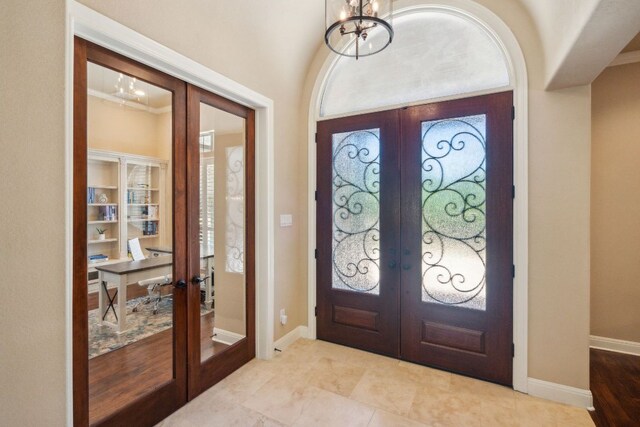 1113 Lions Lair, Leander, TX 78641 - foyer with french doors and a chandelier
