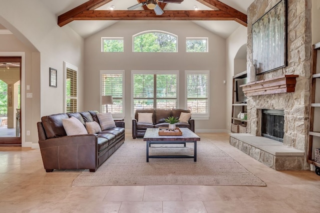1113 Lions Lair, Leander, TX 78641 - living area with ceiling fan, beamed ceiling, arched walkways, high vaulted ceiling, and a stone fireplace
