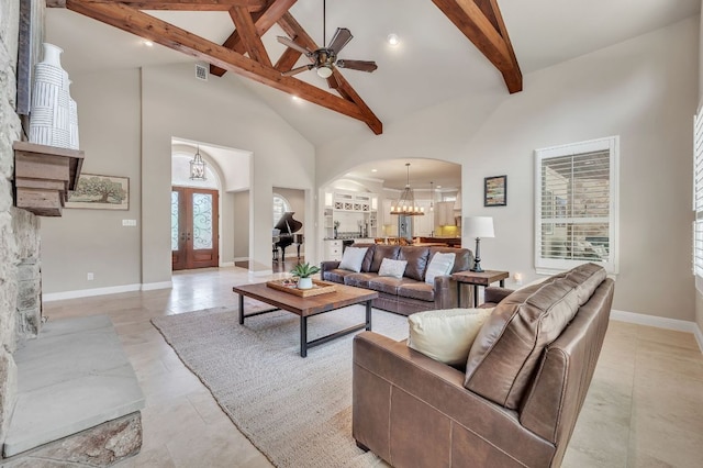 1113 Lions Lair, Leander, TX 78641 - living area with high vaulted ceiling, arched walkways, beam ceiling, ceiling fan, and french doors