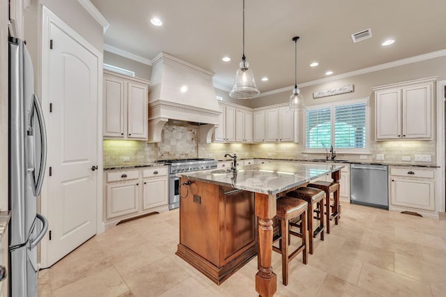 1113 Lions Lair, Leander, TX 78641 - kitchen with stainless steel appliances, light stone counters, decorative backsplash, a kitchen island with sink, and crown molding