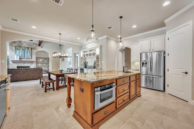 1113 Lions Lair, Leander, TX 78641 - kitchen with appliances with stainless steel finishes, arched walkways, light stone countertops, recessed lighting, and crown molding
