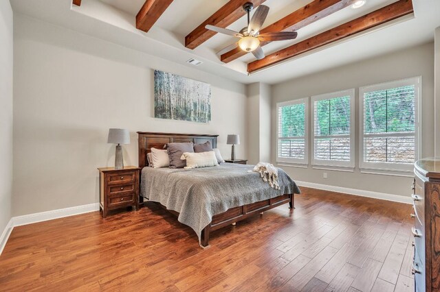 1113 Lions Lair, Leander, TX 78641 - bedroom with multiple windows, beamed ceiling, wood finished floors, and a ceiling fan