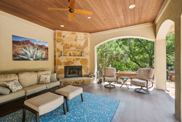 1113 Lions Lair, Leander, TX 78641 - living room with wood ceiling, healthy amount of natural light, wood finished floors, an outdoor stone fireplace, and a ceiling fan