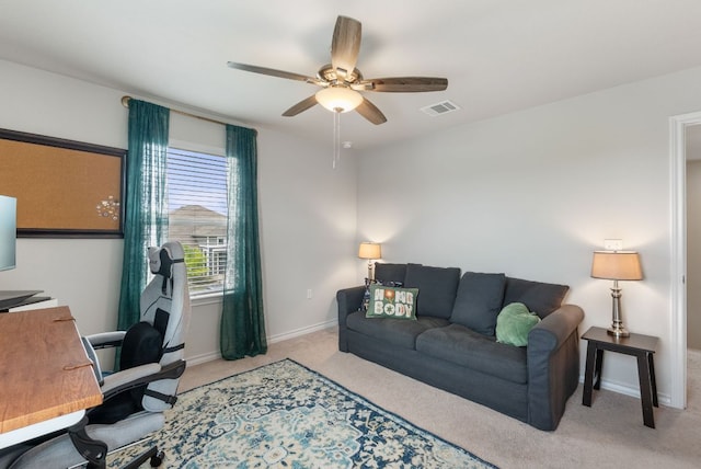 carpeted office space with baseboards, a ceiling fan, and visible vents
