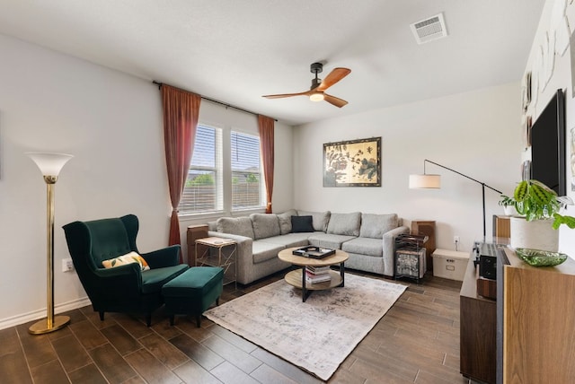 living area featuring dark wood-style flooring, visible vents, and ceiling fan