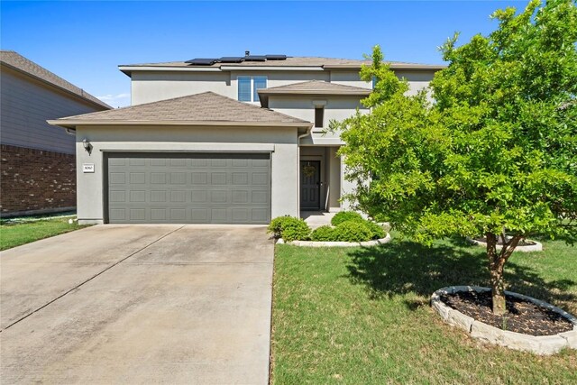 8060 Massa Dr, Round Rock, TX 78665 - view of front of house with solar panels, an attached garage, driveway, a front lawn, and stucco siding