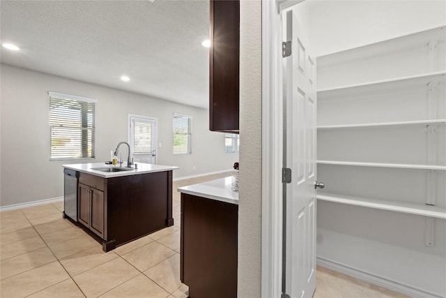 8060 Massa Dr, Round Rock, TX 78665 - kitchen featuring dark brown cabinetry, a kitchen island with sink, recessed lighting, light countertops, and stainless steel dishwasher