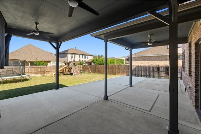 8060 Massa Dr, Round Rock, TX 78665 - fenced backyard featuring a ceiling fan, a trampoline, a playground, and a patio