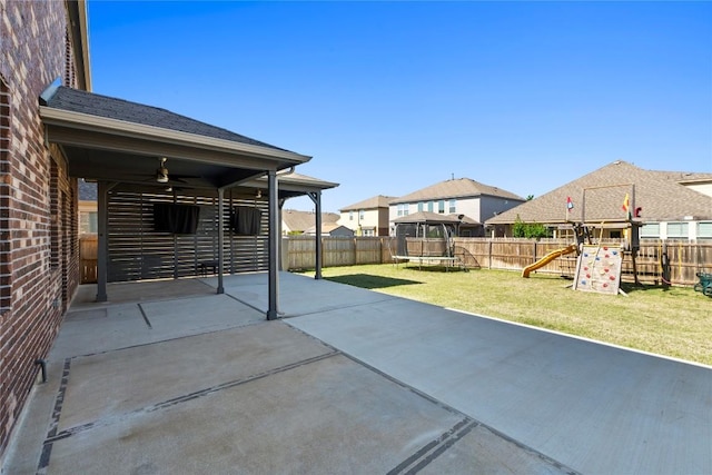 8060 Massa Dr, Round Rock, TX 78665 - fenced backyard featuring a trampoline, a playground, a patio, and a ceiling fan