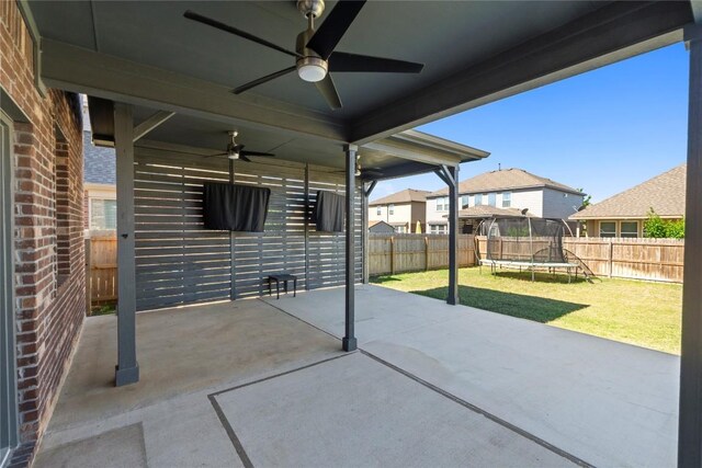 8060 Massa Dr, Round Rock, TX 78665 - fenced backyard featuring a trampoline, a ceiling fan, and a patio
