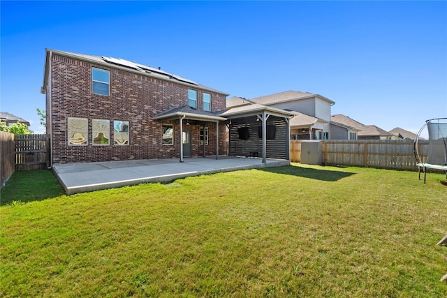 8060 Massa Dr, Round Rock, TX 78665 - back of property featuring a trampoline, a patio area, a fenced backyard, and brick siding