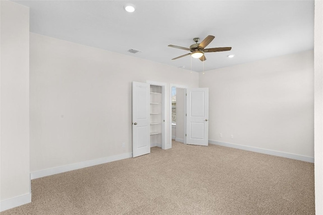 unfurnished bedroom featuring light carpet, visible vents, baseboards, recessed lighting, and ceiling fan