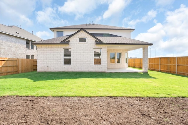 rear view of house featuring a patio area, a fenced backyard, brick siding, and roof with shingles