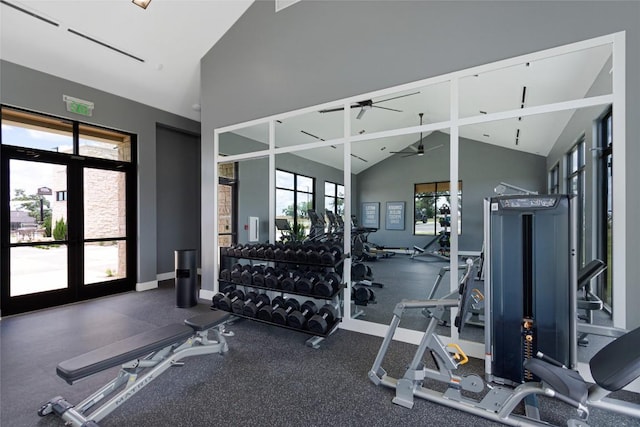 gym featuring high vaulted ceiling, a ceiling fan, and baseboards