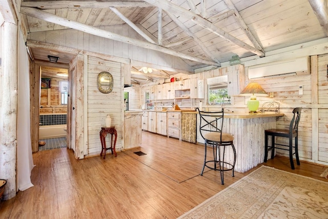 kitchen featuring wood ceiling, vaulted ceiling with beams, wood walls, and light wood-style flooring
