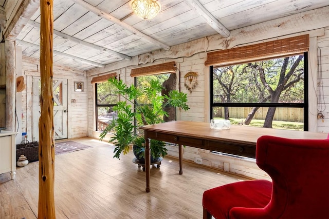sunroom / solarium featuring beam ceiling