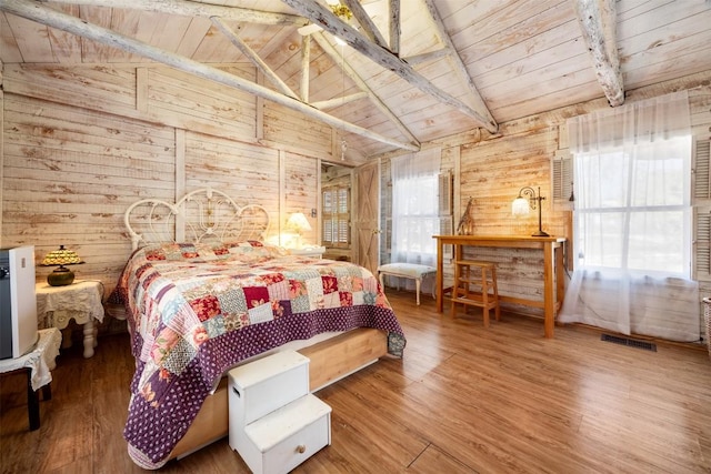 bedroom featuring wood ceiling, visible vents, and wood walls